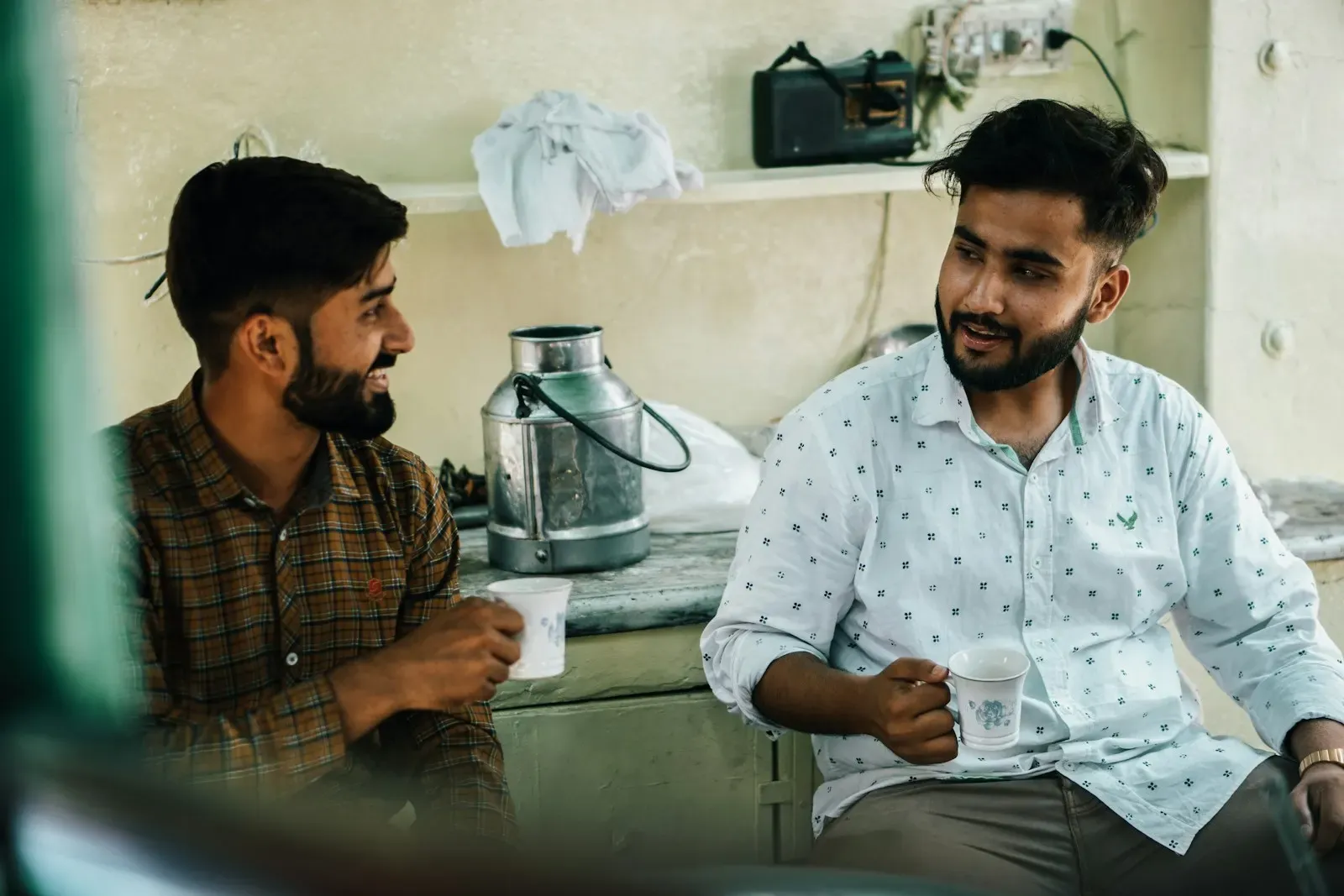 Two colleagues talking through work over tea