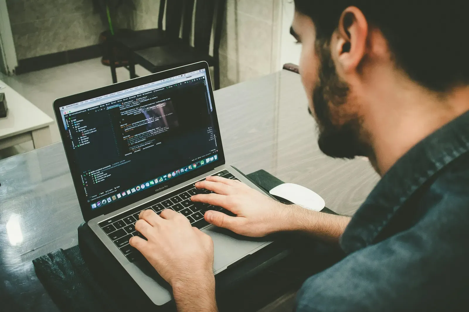 Engineer typing code on a laptop