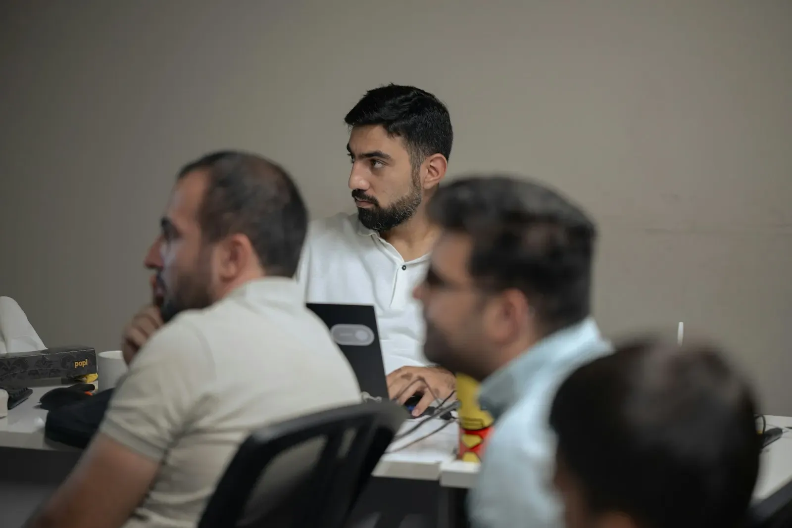 Colleagues talking around a meeting table