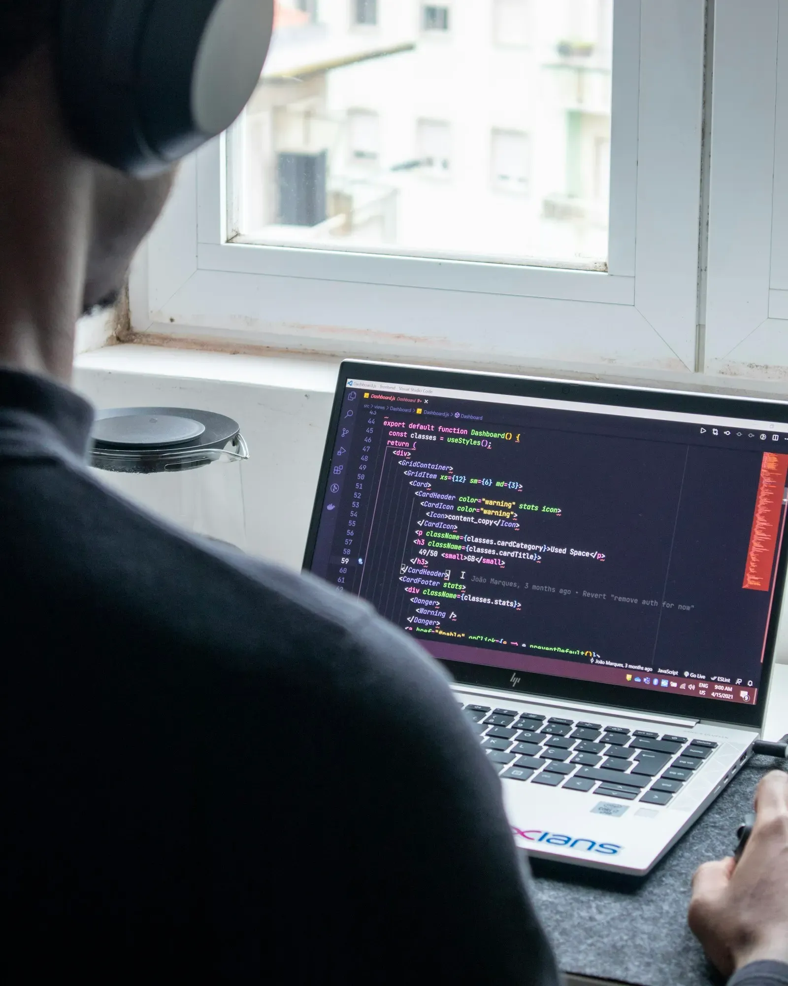 Engineer working through code on a laptop