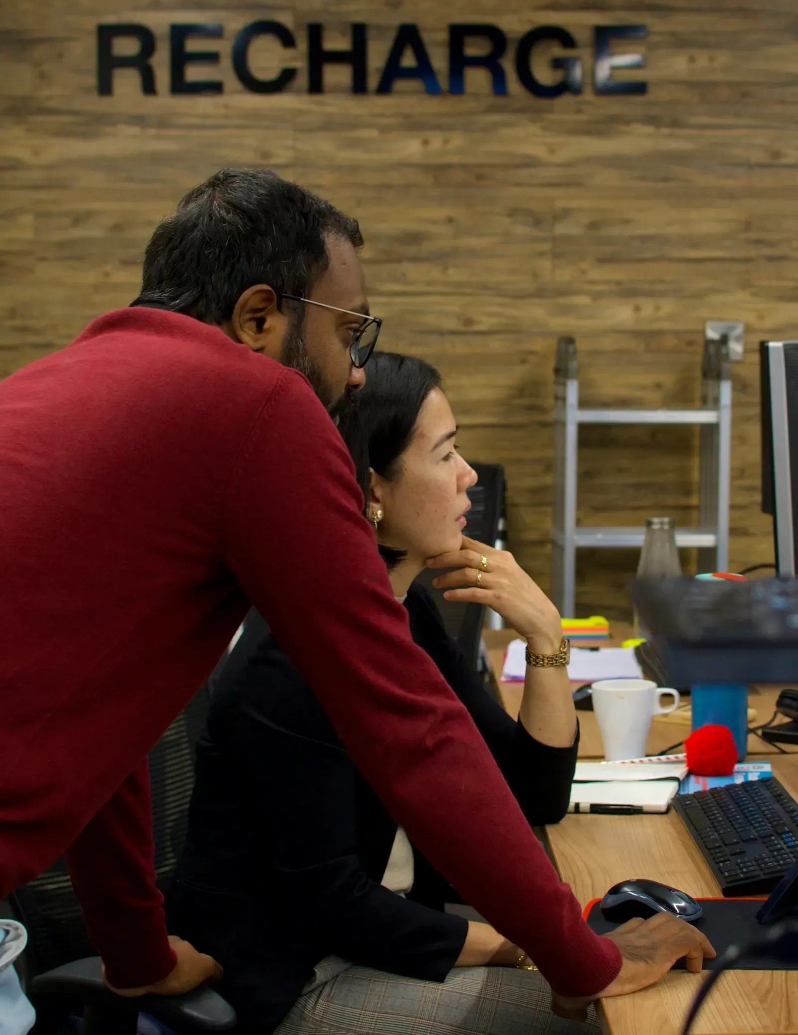 Two colleagues reviewing work together in an office