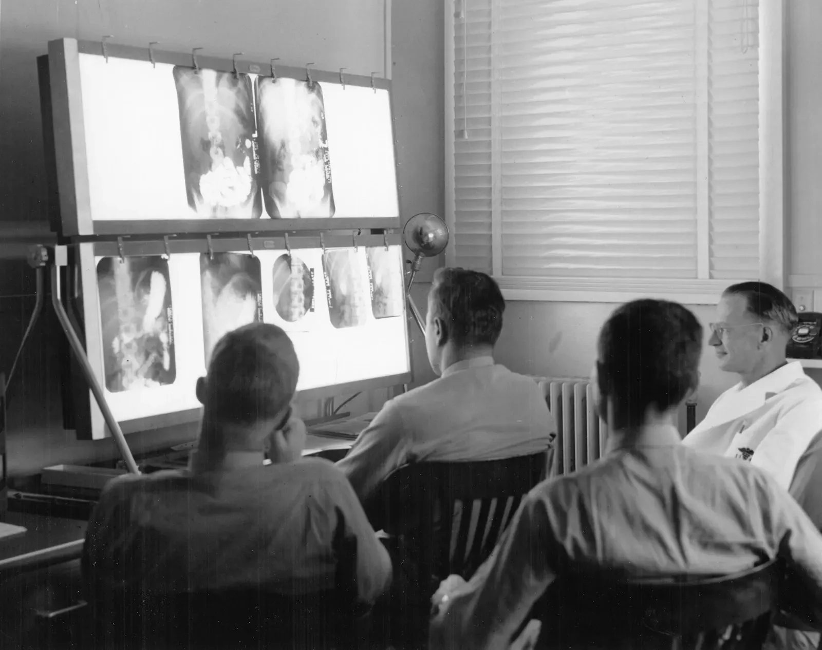 Doctors reviewing X-rays on a light board