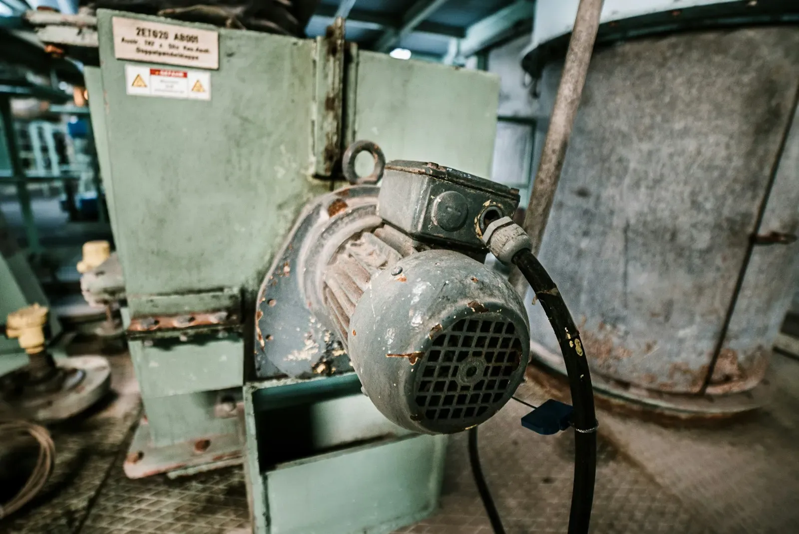 Industrial electric motor mounted on a machine in a workshop