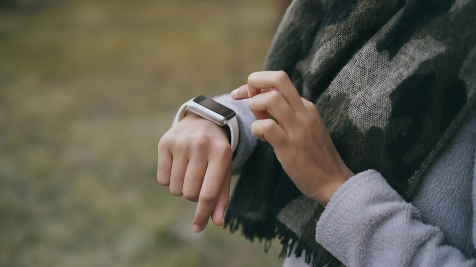 Person checking a coaching prompt on a smartwatch
