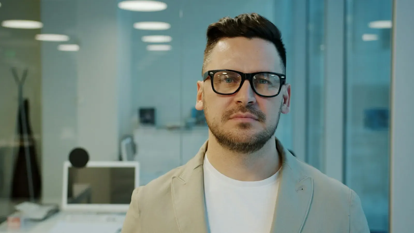 Founder in glasses standing in a modern office