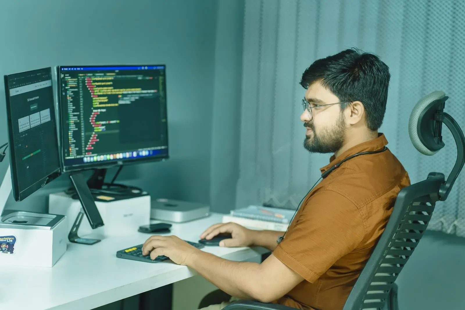 Engineer testing an application across two screens
