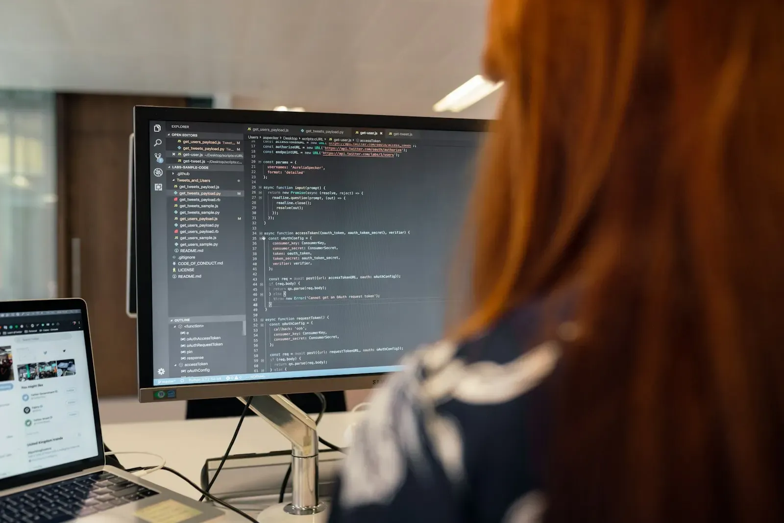 Developer reviewing retrieval code on her monitor