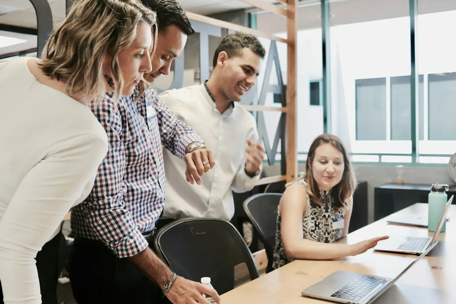 Colleagues gathered at a desk reviewing work