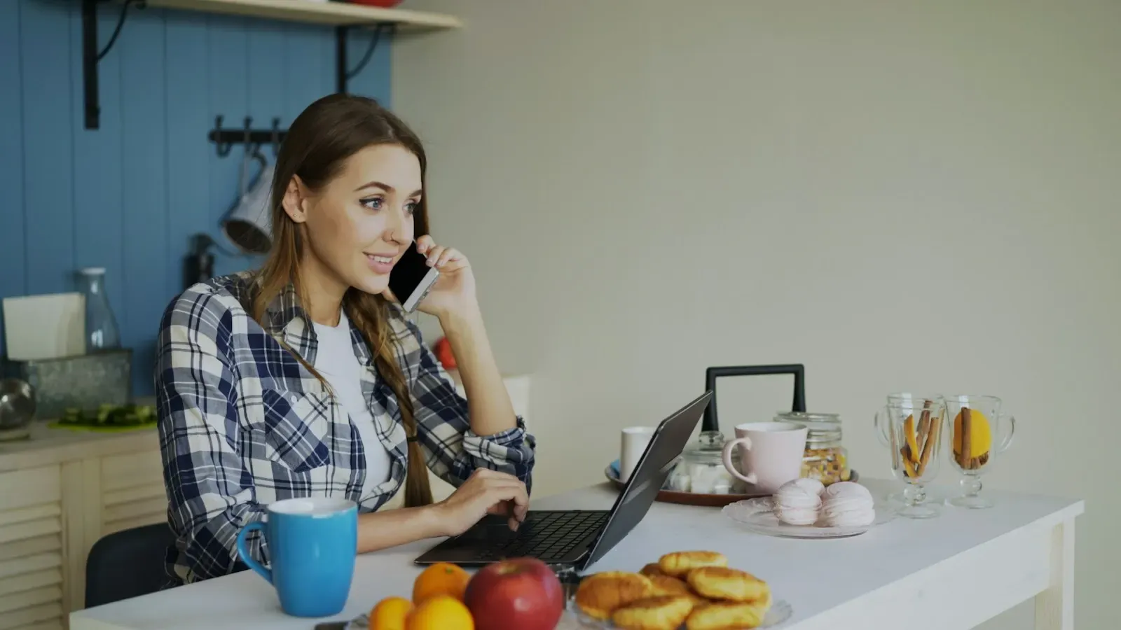 Support agent on a call while working on her laptop