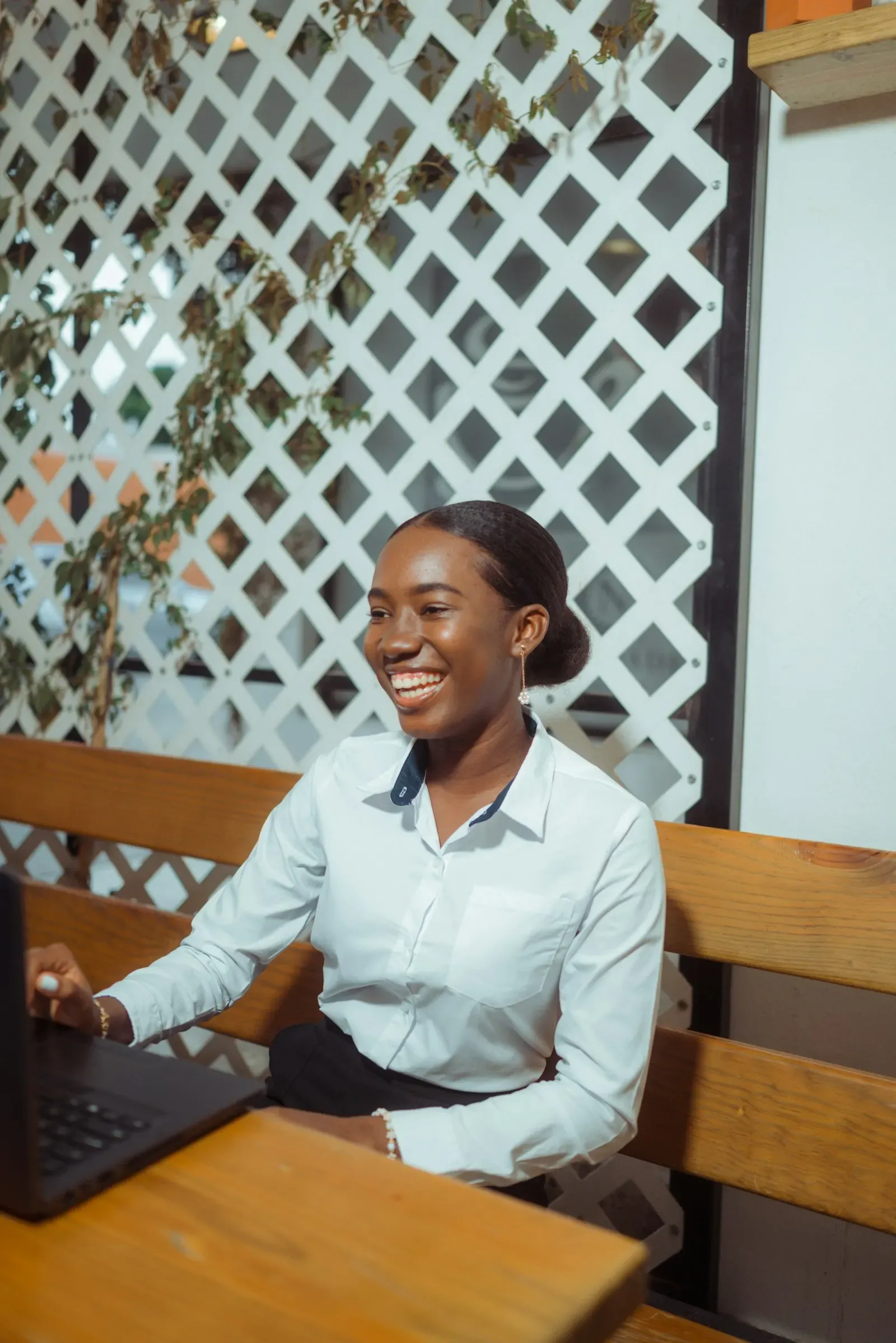 Professional smiling while writing at her desk