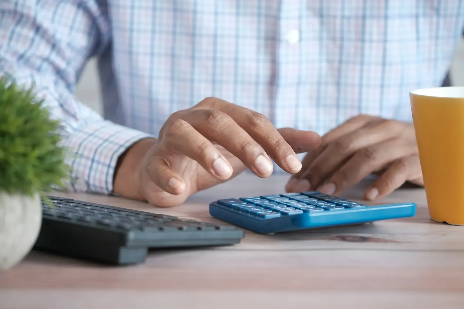 Finance specialist checking figures with a calculator