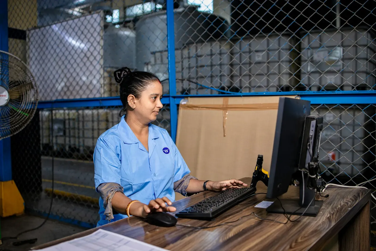 Warehouse coordinator working at a desktop computer