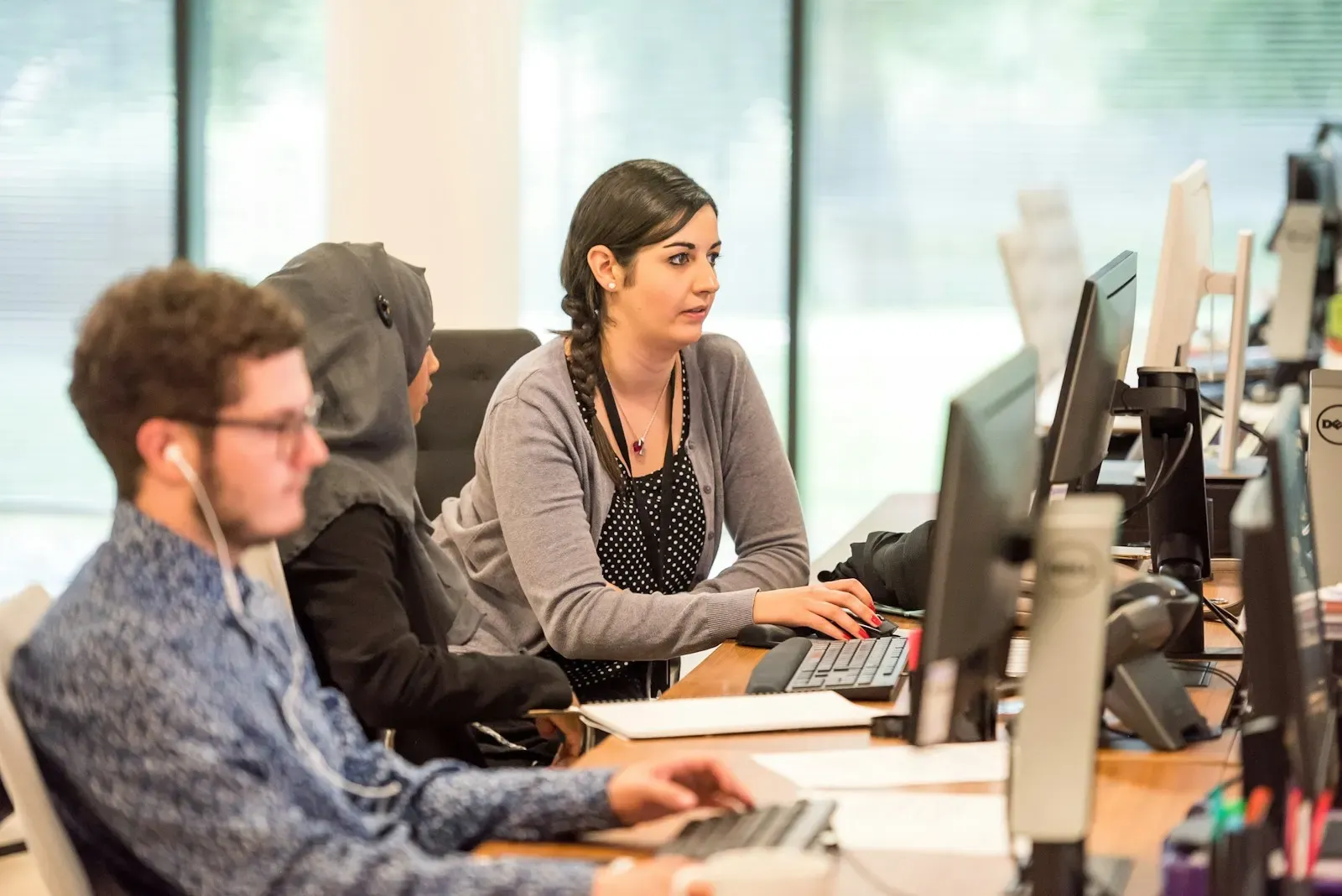 Operations team working at rows of desktop computers