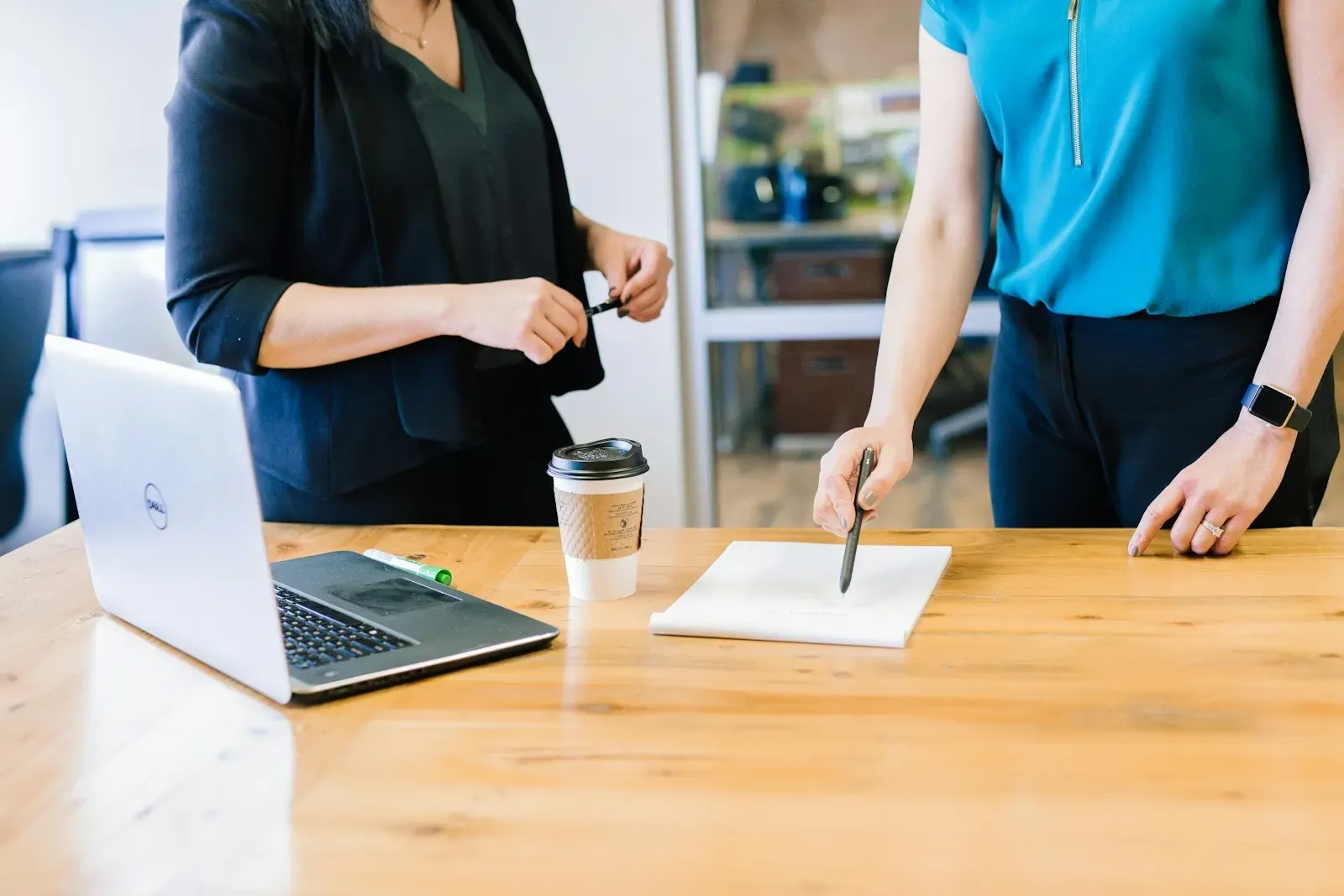 Two colleagues checking extracted document fields at a desk