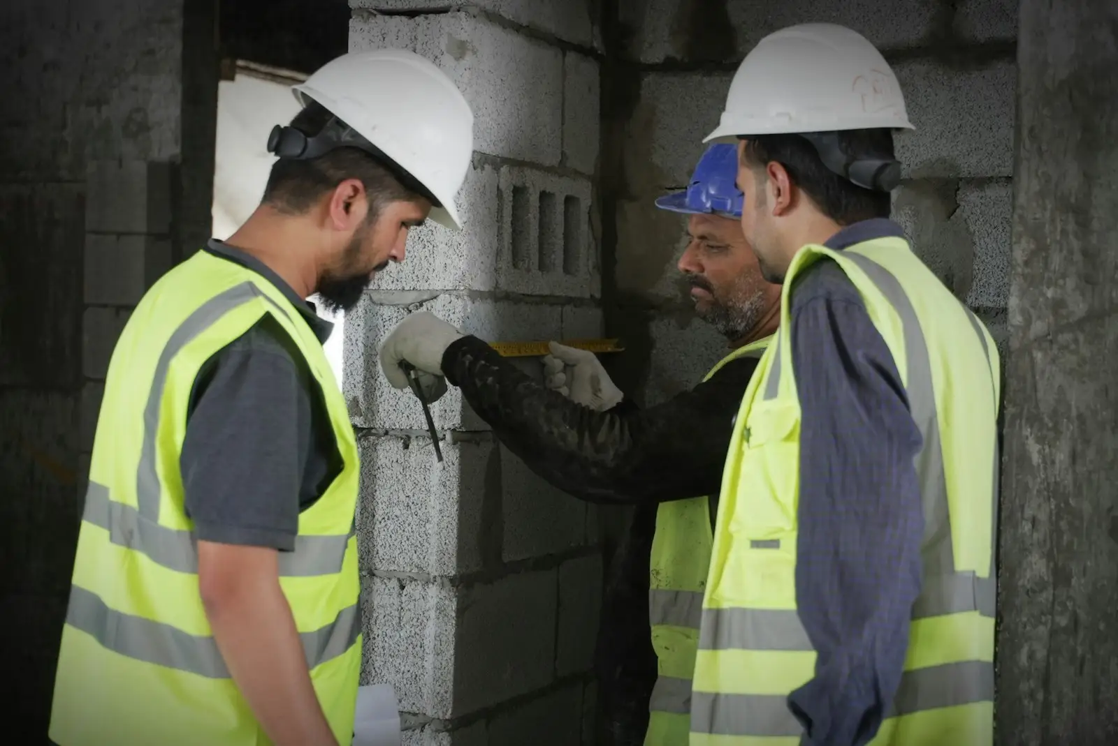 Construction workers in hard hats and high-visibility vests