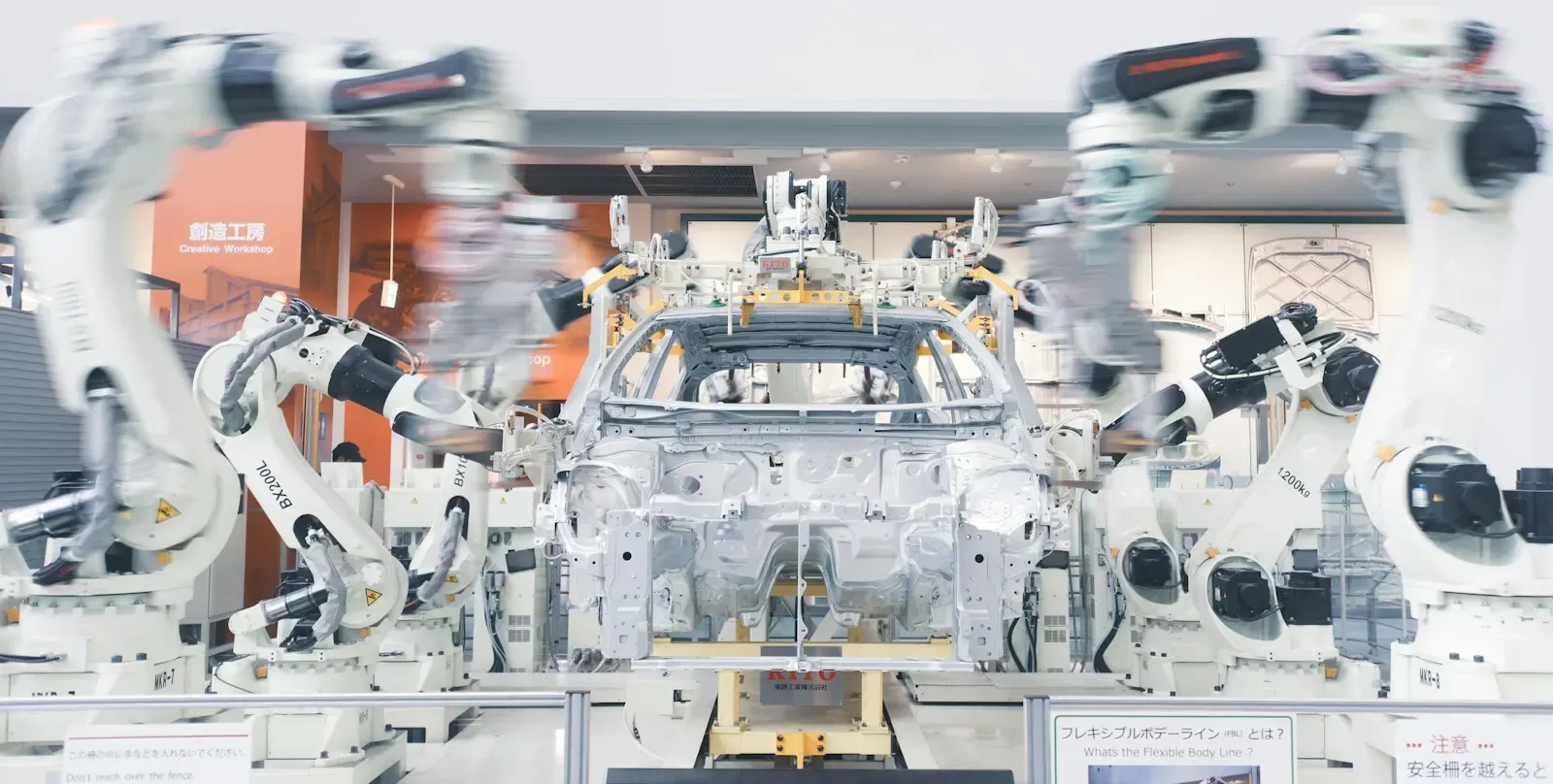 Robotic arms assembling a car body on a factory line