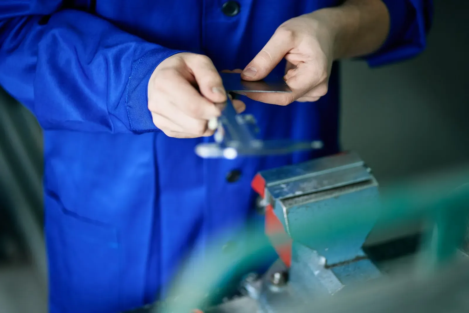 Inspector measuring a machined part with calipers