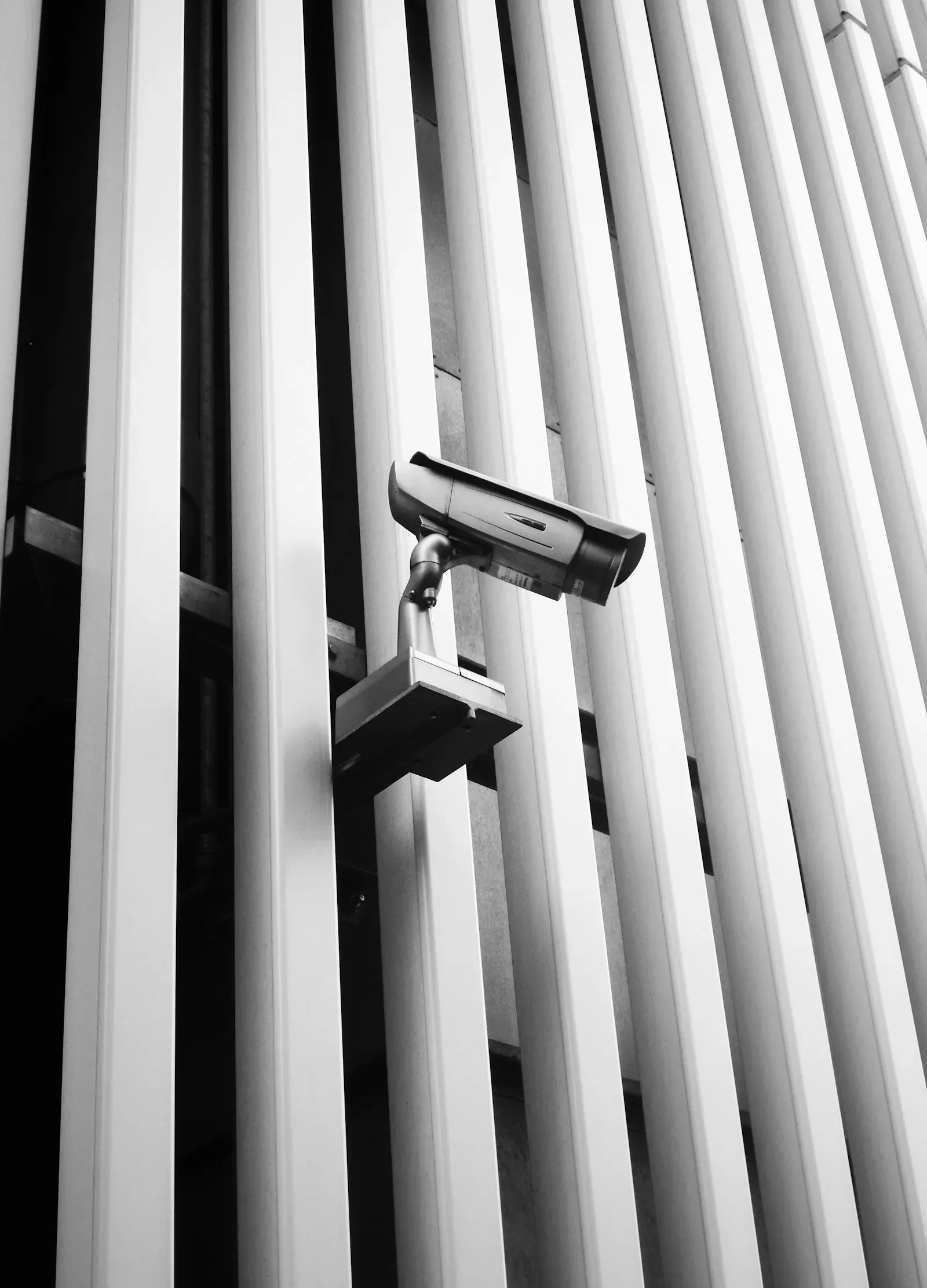 Security camera mounted on the side of a white building