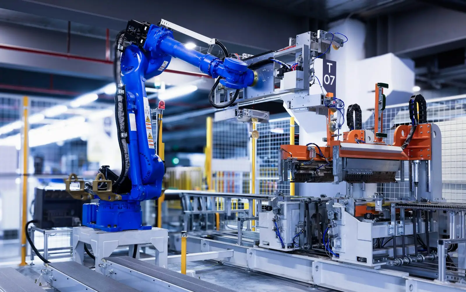 Industrial robot arm working on a factory production line
