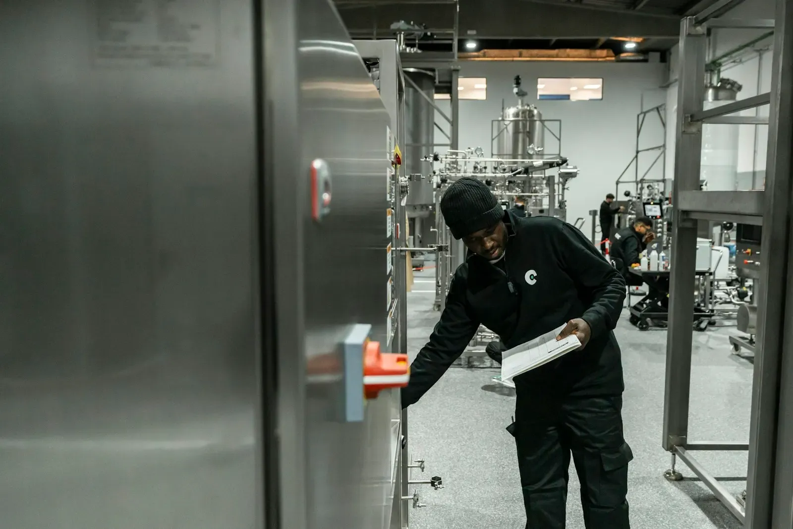 Engineer inspecting equipment in a modern factory