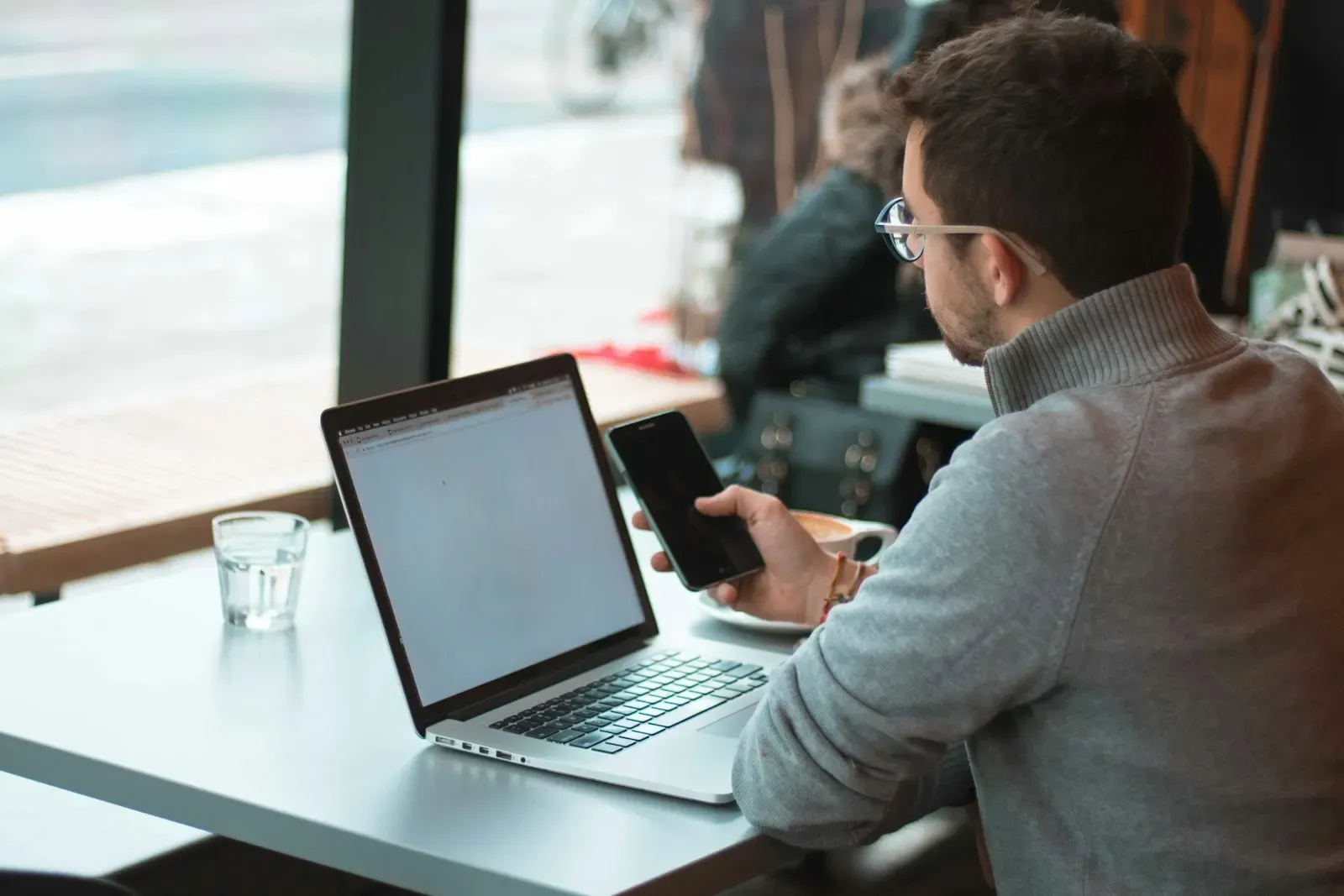 Product manager working on a laptop by a window