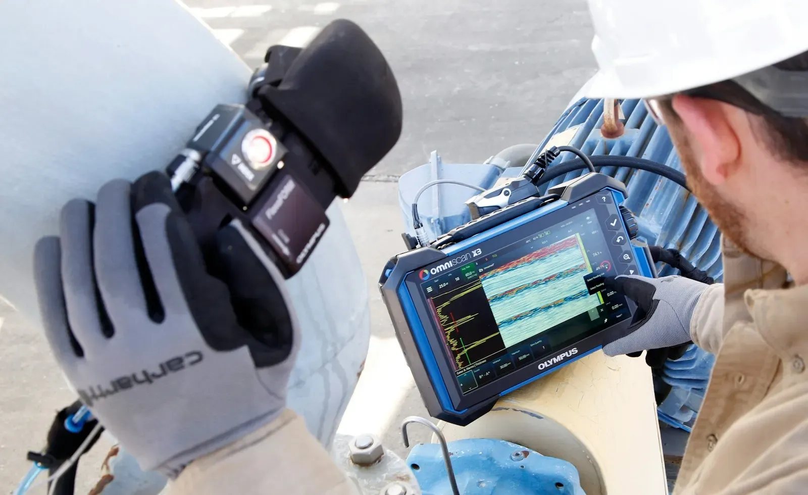 Engineer reading sensor data on a handheld device in the field