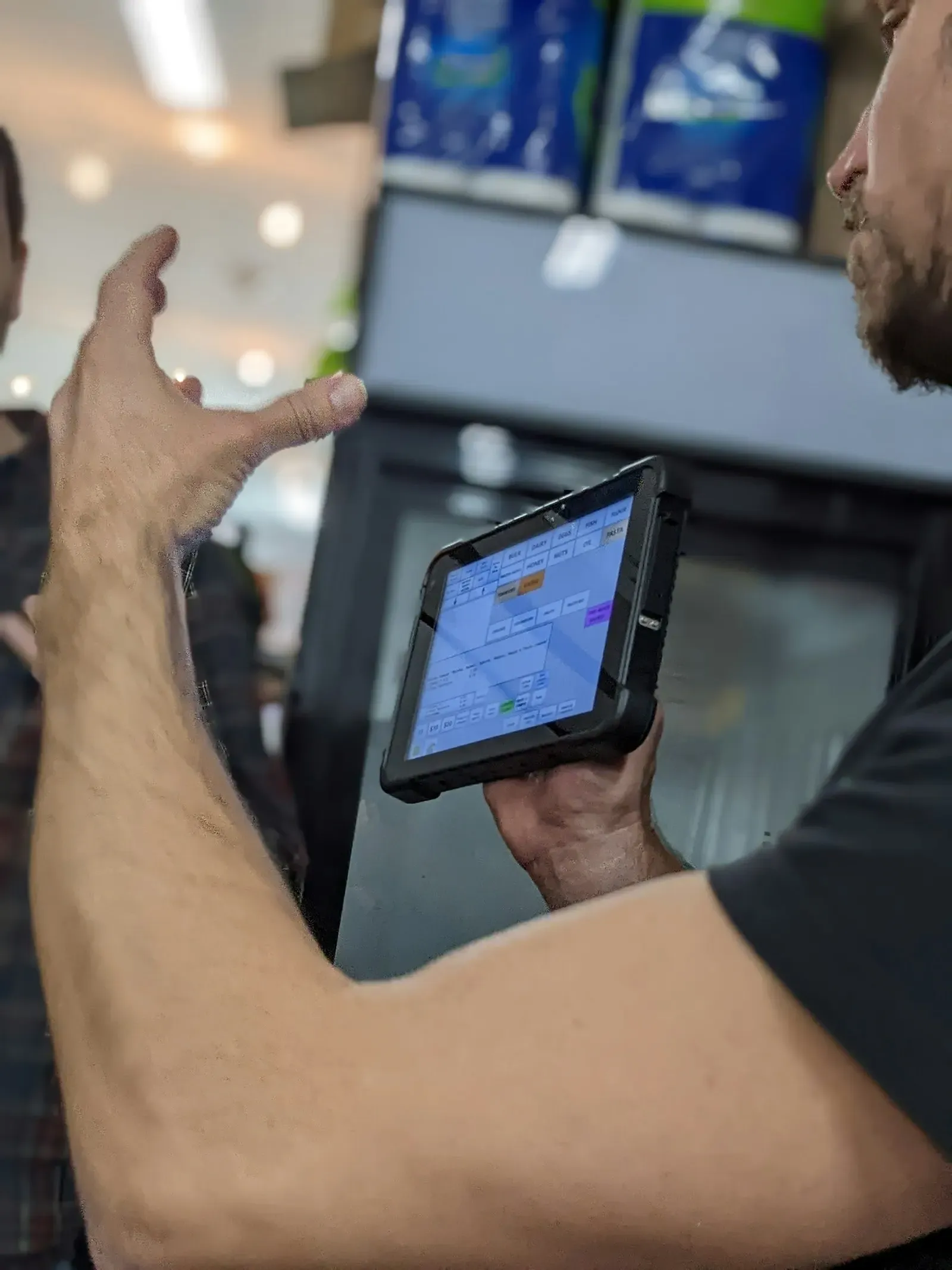 Person holding a rugged tablet showing device data