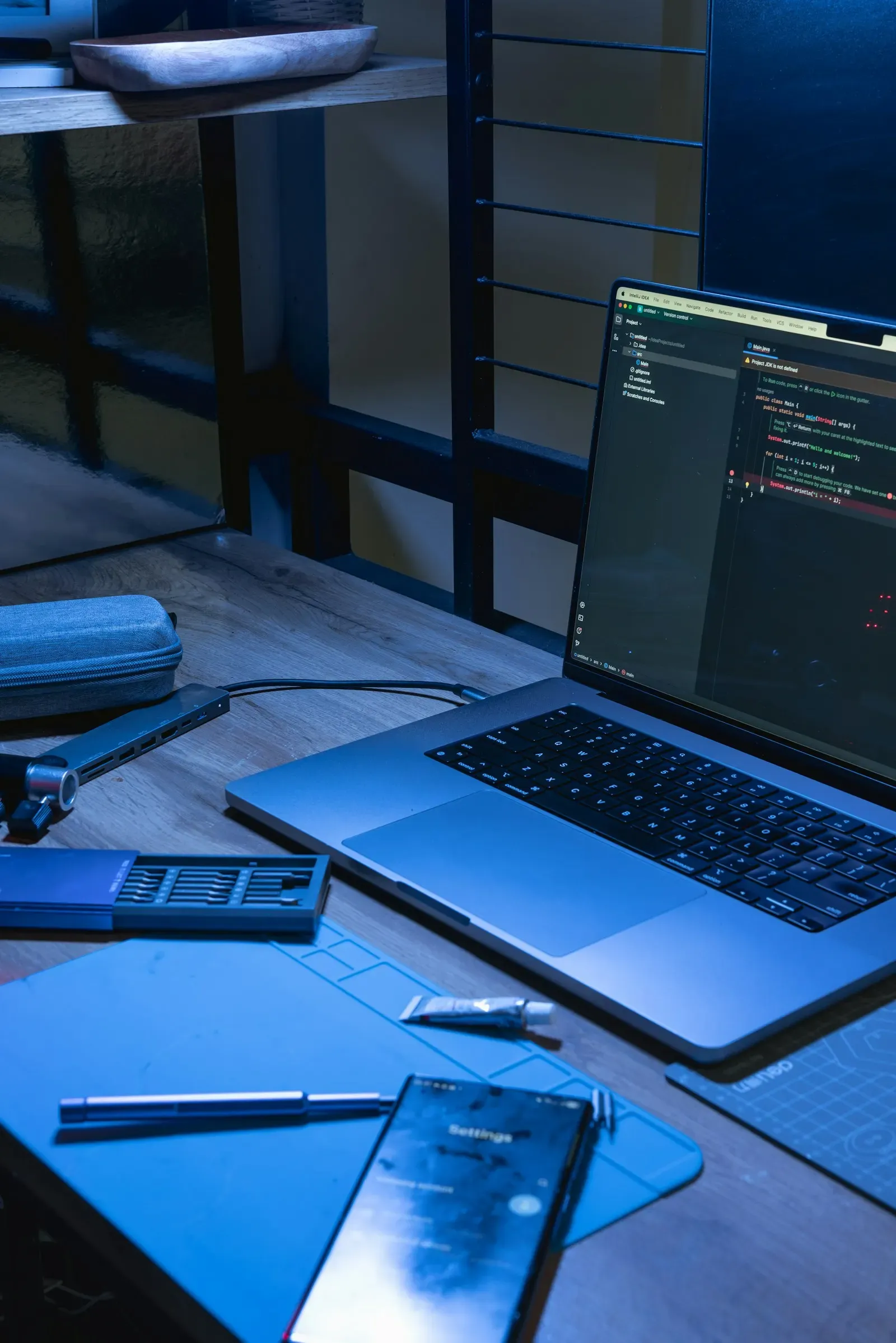 Laptop open on a desk with code on the screen