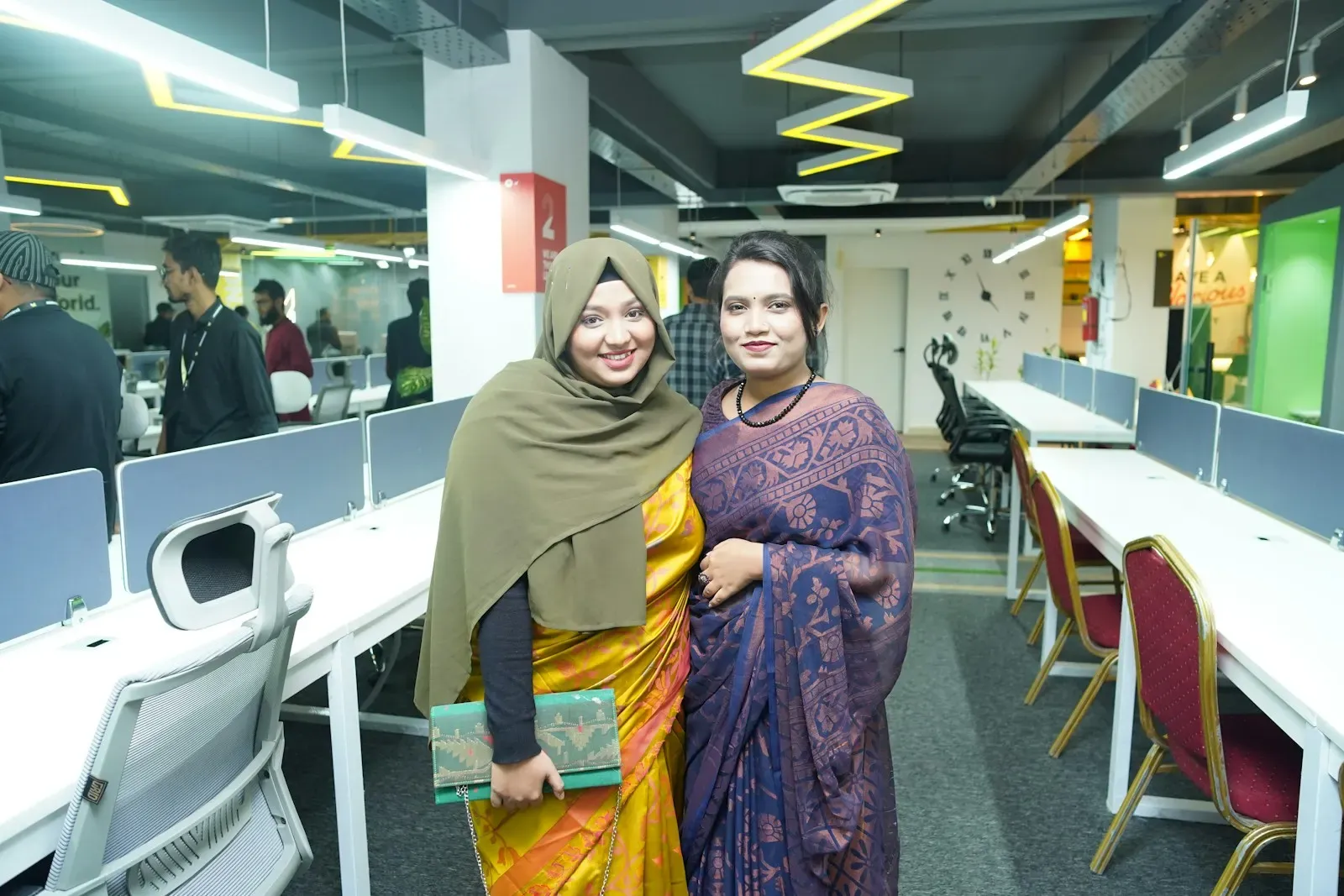 Colleagues standing together in an open office