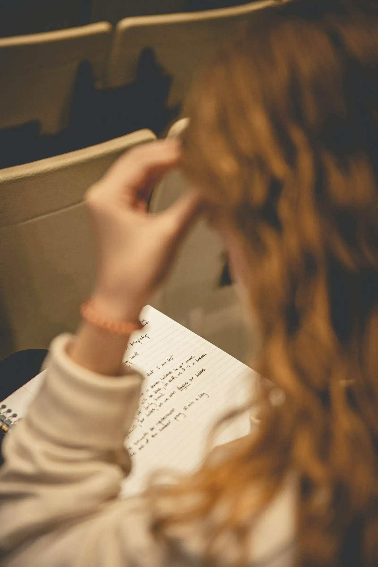 Person writing notes by hand