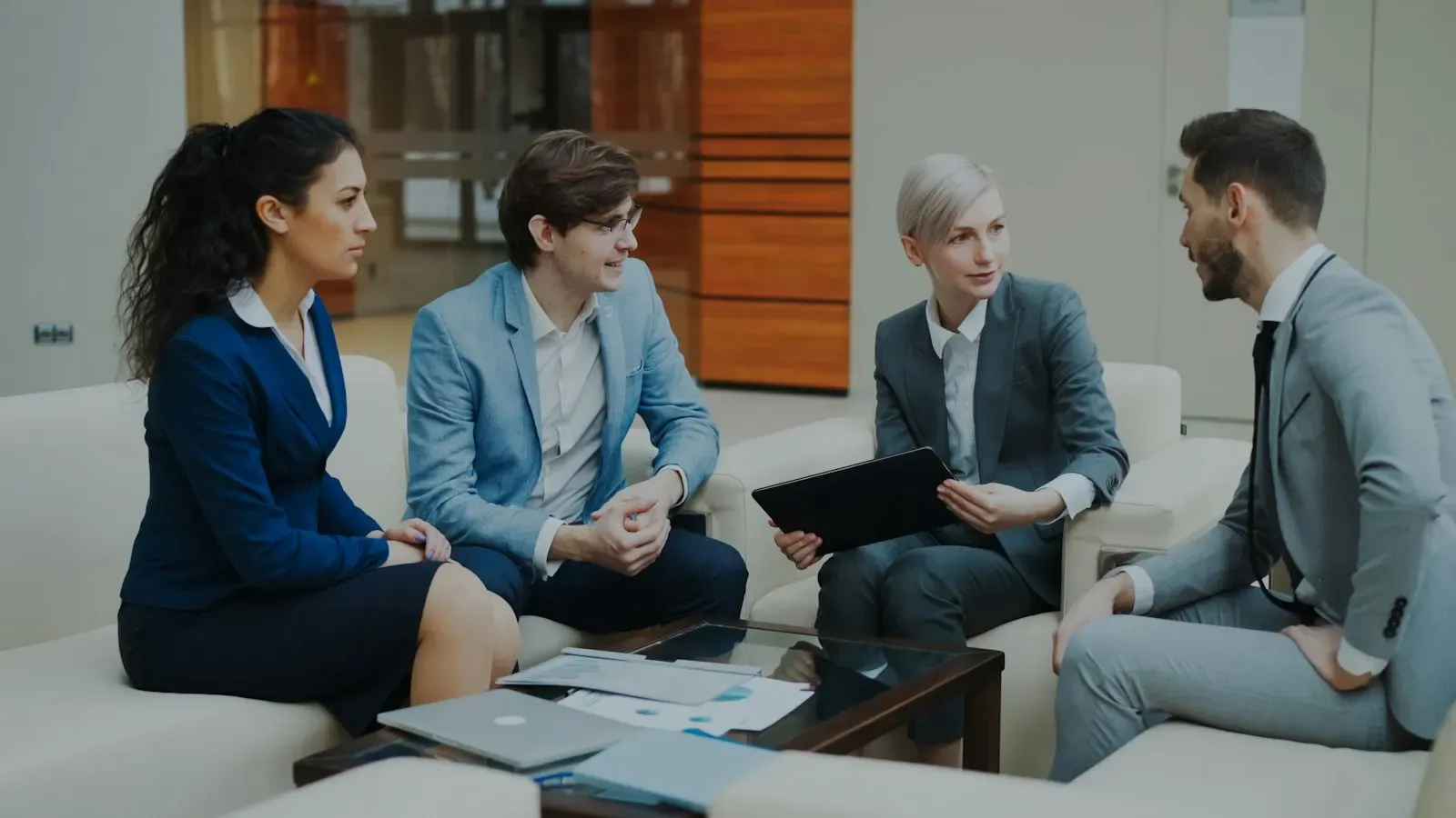 Team discussing research findings in a lounge meeting