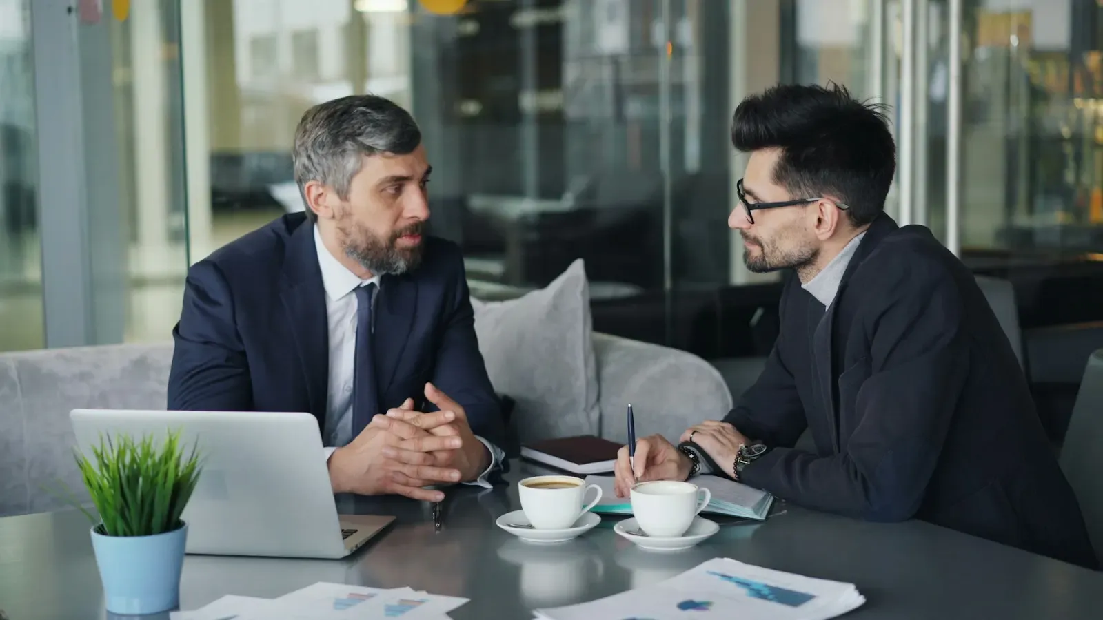 Two lawyers discussing contract terms at a table