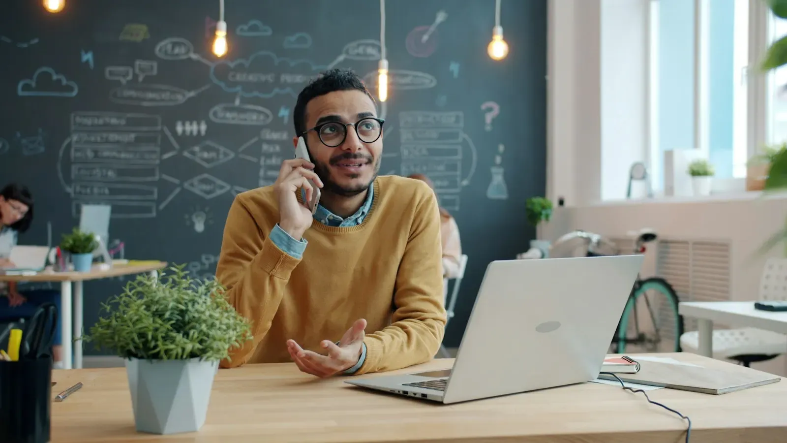 Coordinator on a phone call at his laptop
