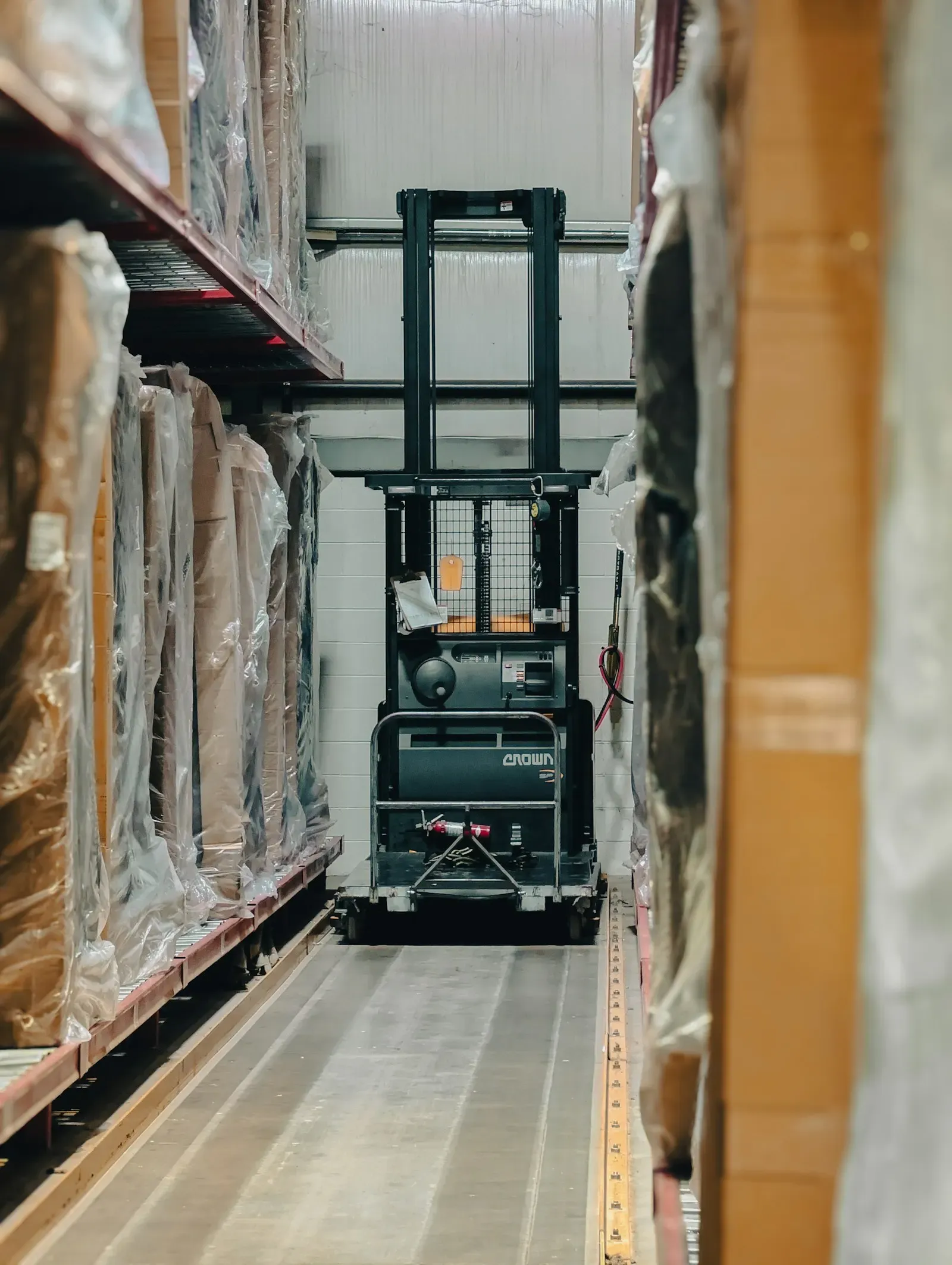 Warehouse aisle stacked with wrapped pallets