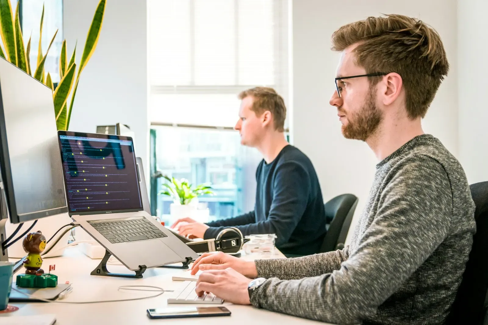 Software engineers working at their monitors