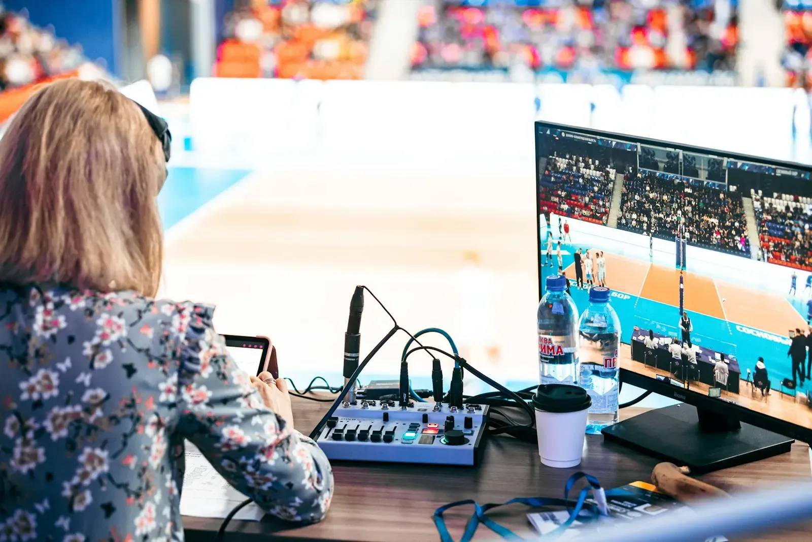 Producer watching a live match feed at a desk