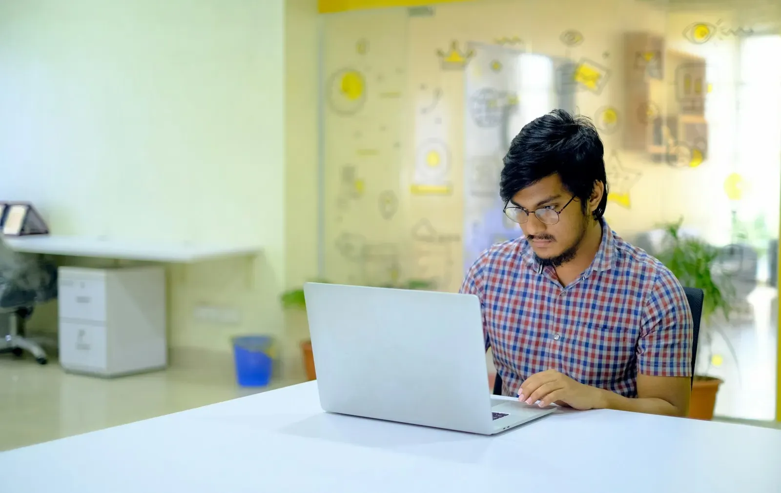 Developer at a laptop in a bright office