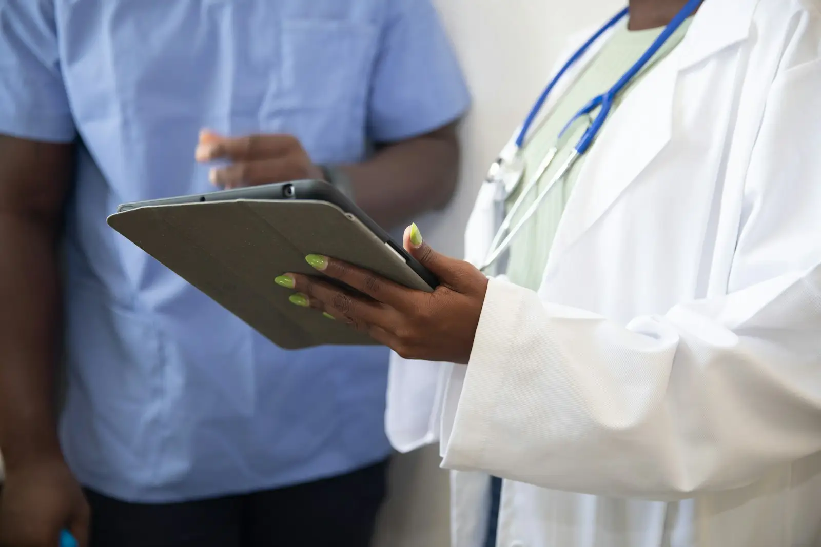 Clinician walking a patient through intake on a tablet