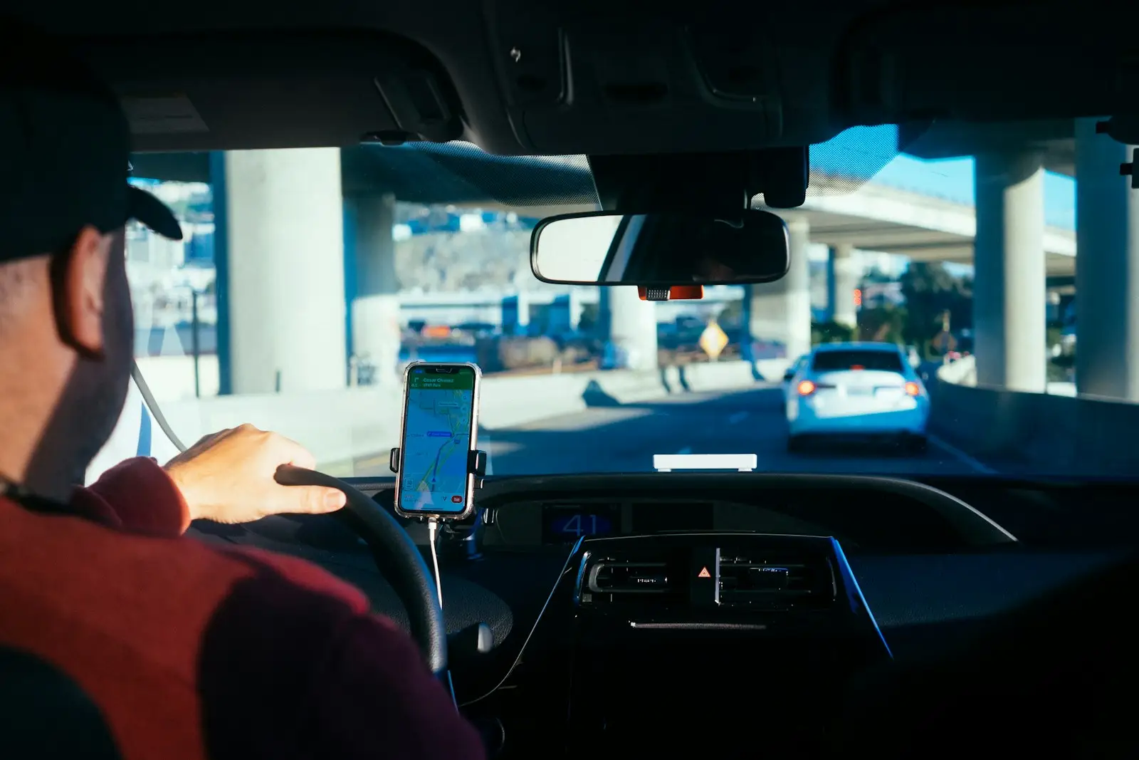 Driver using a phone app mounted on the dashboard
