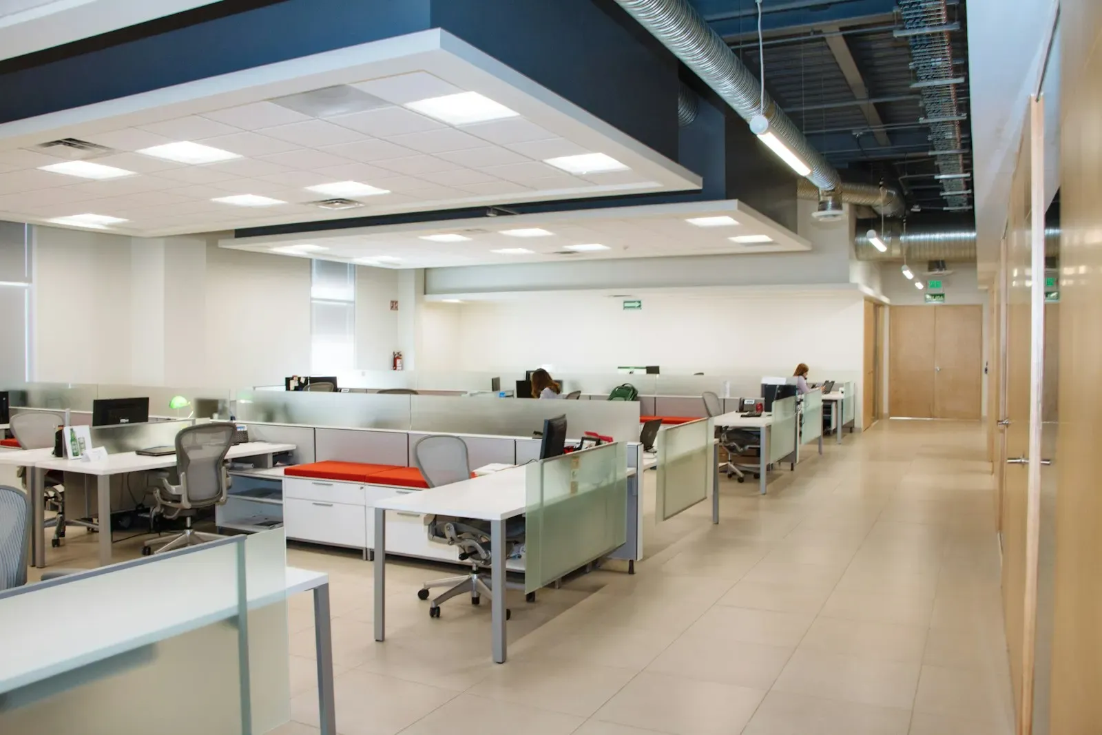 Open-plan office with rows of white desks