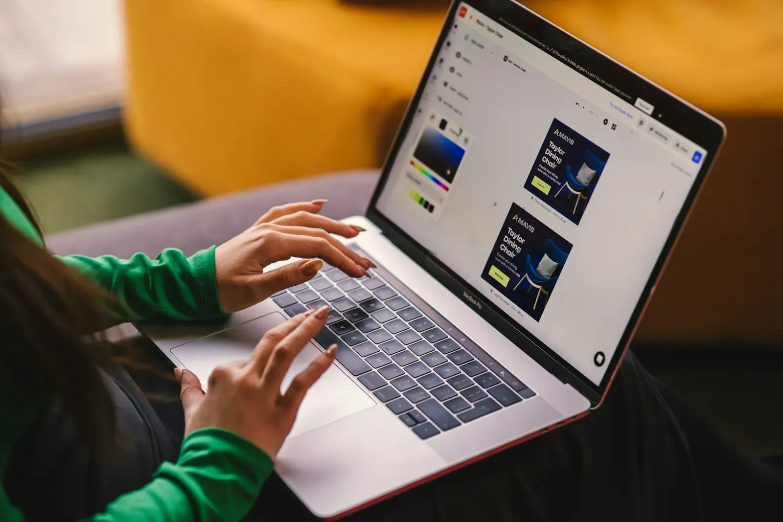 Woman on a sofa working on a laptop