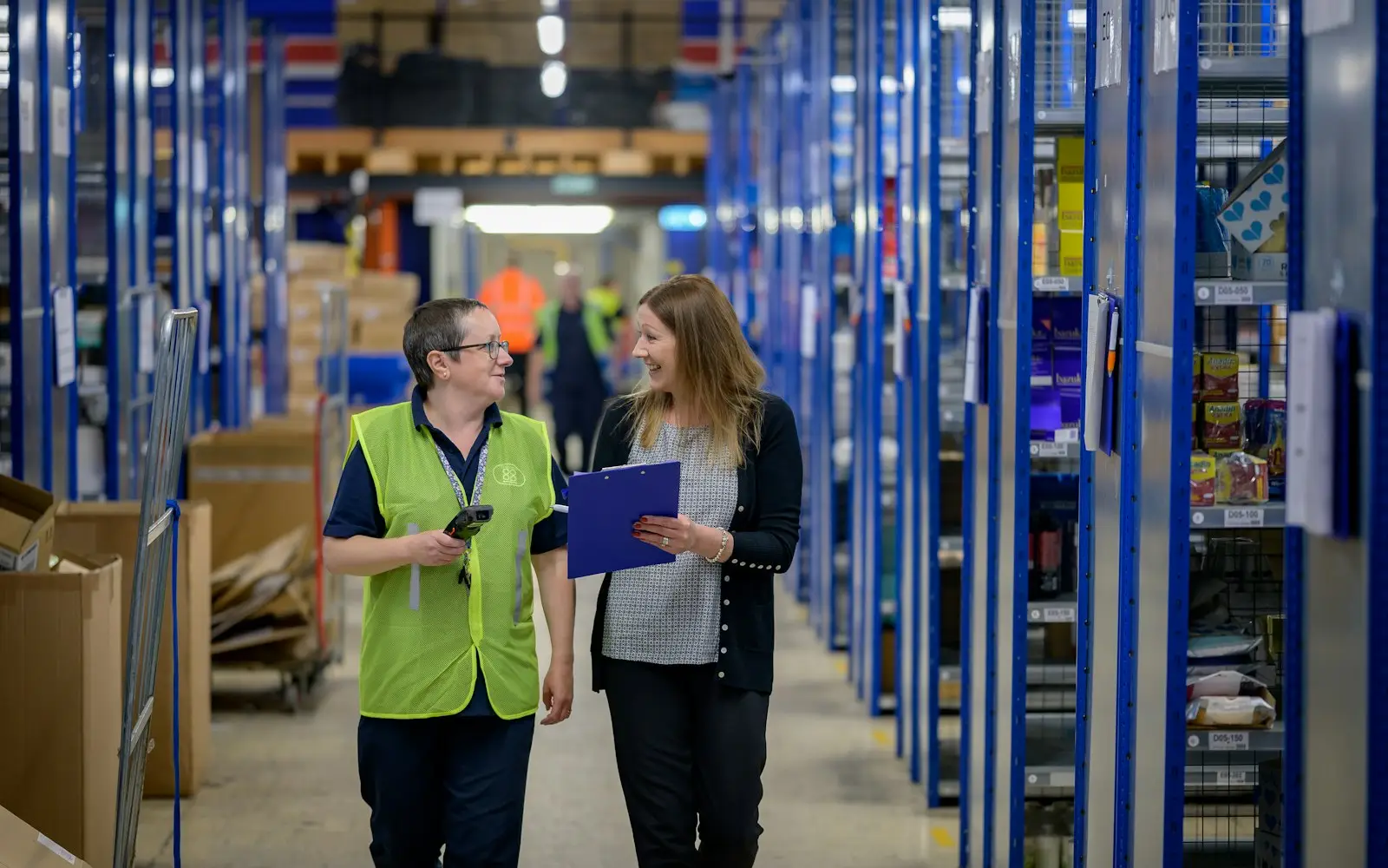 Operations staff walking a warehouse aisle