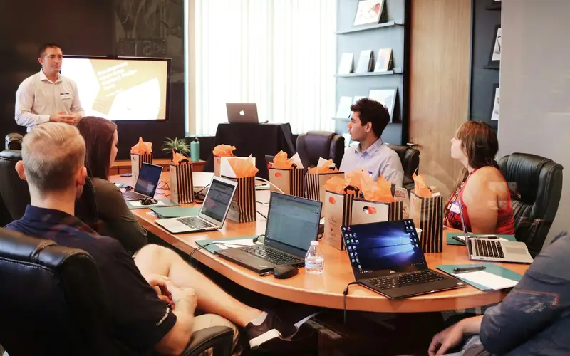 Sales lead presenting to a team around a table