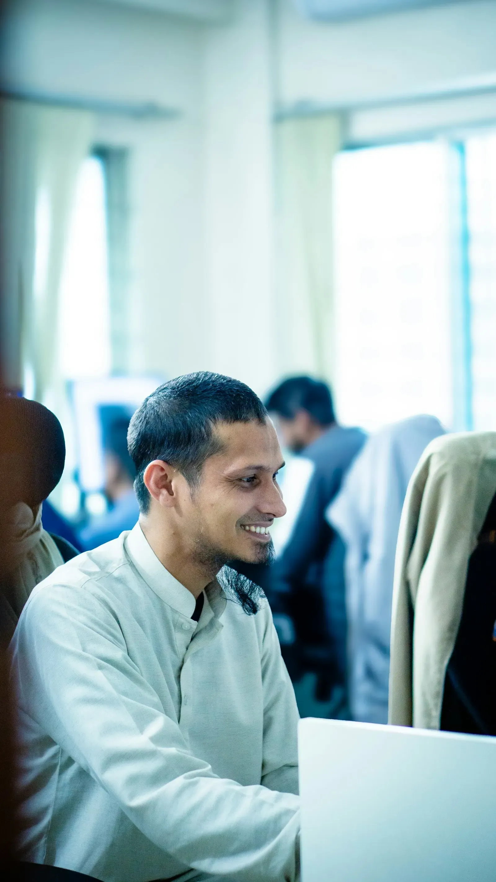 Engineer smiling while working with colleagues